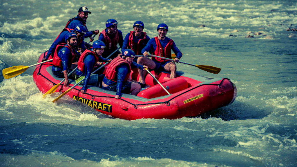 Team members white water rafting in a river in Turkey at their partner event