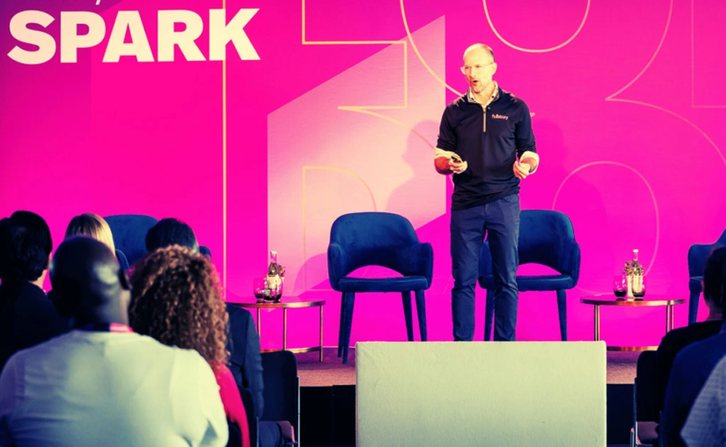 A man delivers a presentation at a spark event, engaging the audience with his insights and expertise.